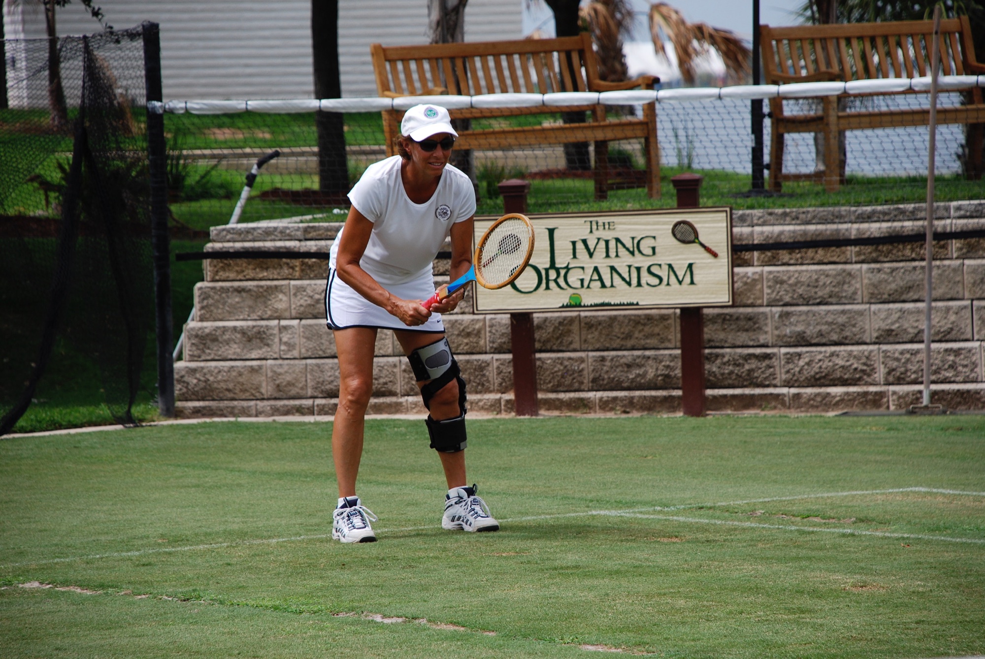 A backhand in front of The Living Organism sign